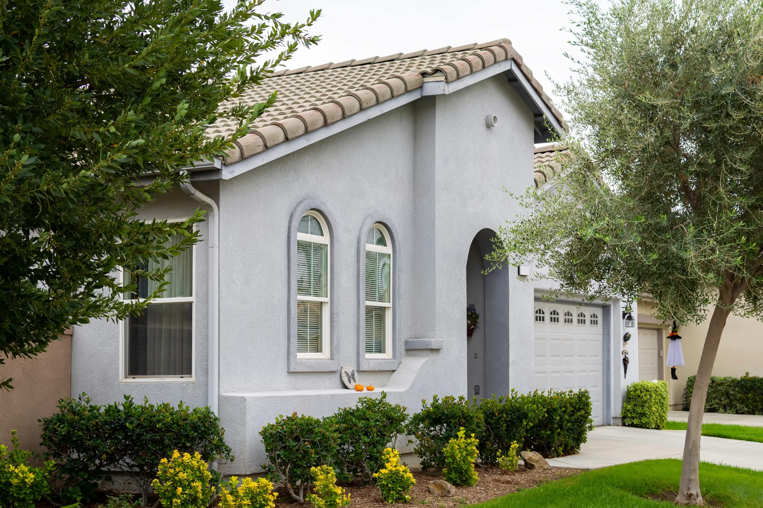 Light blue stucco house with roofing